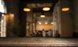 © kishivan - blurred background of bar and dark brown desk space of retro wood