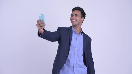 Wall Mural - Happy young Indian businessman taking selfie