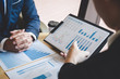 © Ngampol - Business people team discuss and analyzing on meeting to planning investment project working and presentation strategy of business making conversation with partner, financial and accounting concept
