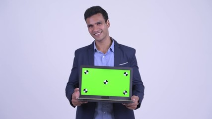 Wall Mural - Happy young Indian businessman showing laptop and looking surprised