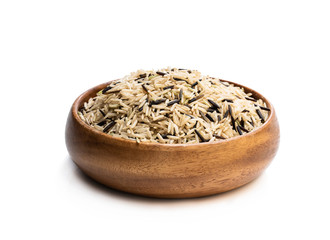 Wild brown basmati rice in a wooden bowl isolated on white