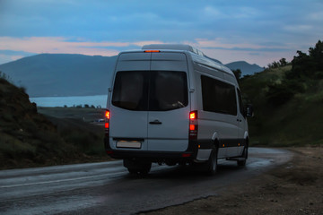 Wall Mural - minibus moves along the mountain winding road to the sea