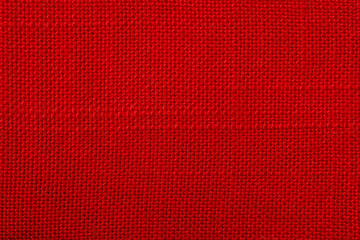 Wall Mural - Red fabric background texture. Detail of textile material close-up