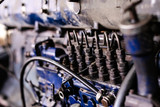 Fototapeta  - Mechanic opened the locking valve mechanism. Disassemble engine block vehicle. Old motor capital repair. Car service concept