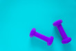 © Jaimie - Fitness equipment with womens purple weights/ dumbbells isolated on a light sky blue background with copyspace
