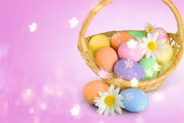 Wall Mural - Easter basket filled with colorful eggs on a white background