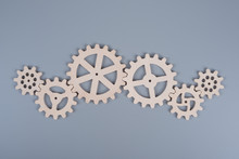 Gears Assembled In A Puzzle Mechanism To Work On A Gray Background. Business Concept Idea, Partnership, Cooperation, Teamwork.