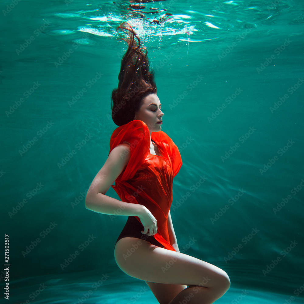Mystical underwater portrait of a beautiful young woman in a orange dress.  Girl swimming underwater Stock Photo | Adobe Stock, image size:1000x1000
