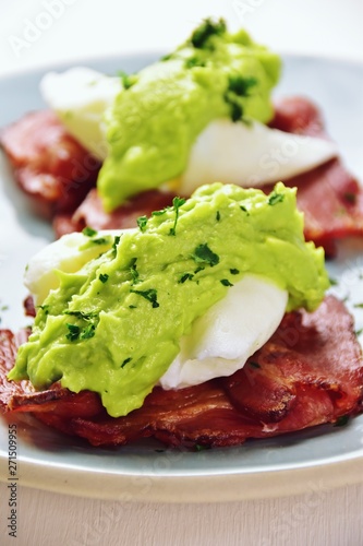Paleo eggs benedict with avocado sauce on a bacon mat - Buy this ...