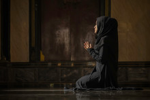 Muslim Women Wearing Black Shirts Doing Prayer According To The Principles Of Islam..