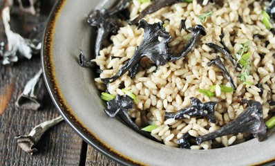 Wall Mural - black chanterelle risotto. Black Trumpet mushrooms recipe. Italian food. place for text. copy space.