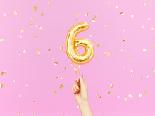 Six Year Birthday. Female Hand Holding Number 6 Foil Balloon. Six-year Anniversary Background. 3d Rendering