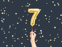Seven Year Birthday. Female Hand Holding Number 7 Foil Balloon. Seven-year Anniversary Background. 3d Rendering