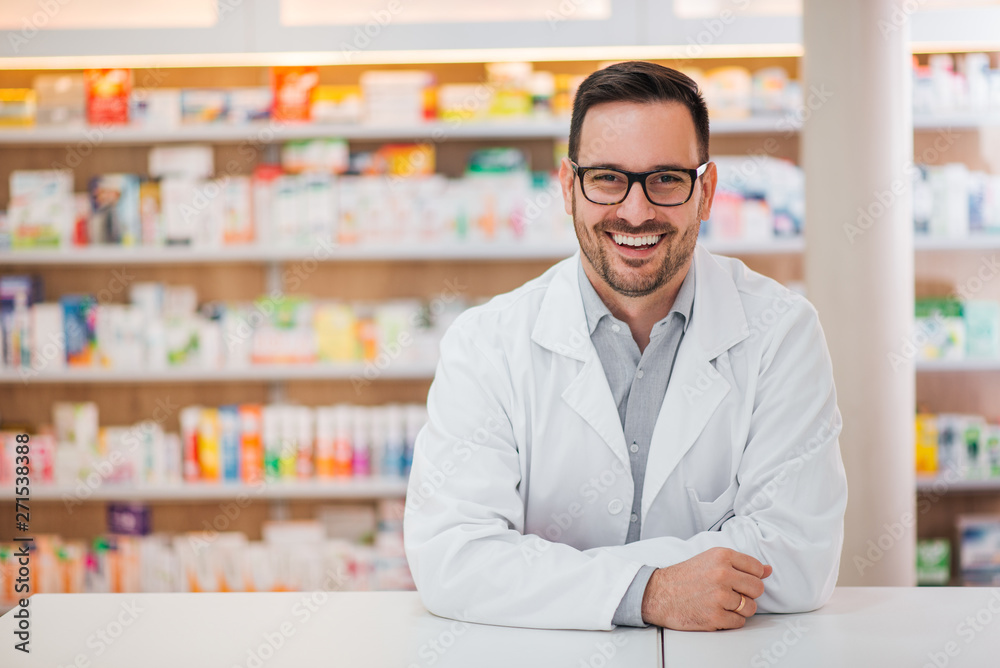 Smiling portrait of a handsome pharmacist. - obrazy, fototapety, plakaty 
