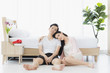 © Bangkok Click Studio - Sexy couple in pajamas sit on floor in bedroom..