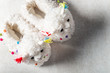 Cute soft 3d llama slippers on the grey background