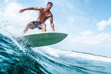 Young Surfer With Lean Muscular Body Rides The Tropical Wave