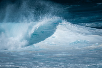 foamy wave breaks on the north shore of oahu in hawaii
