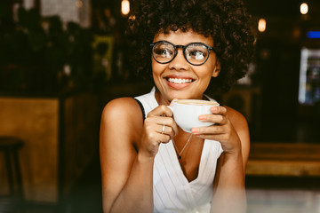 African female relaxing at coffeeshop