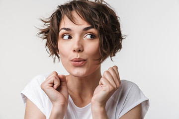 Canvas Print - Young pretty excited shocked woman posing isolated over white wall background.