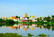 Beautiful scenic view of sacred city Kanchipuram (Kanchi) with colorful traditional houses, gopura of Hindu Temple bright foliage reflekted at calm lake waters, Tamil Nadu, South India
