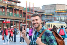 Tourist In Asia Showing Peace Sign 