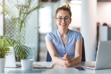 Wall Mural - Portrait of a young business woman in an office