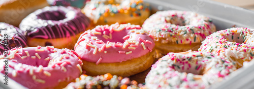 Assorted sweet donuts in a paper box. Poster Mural XXL