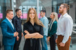 © Alexandr - young beautiful woman on a background of colleagues in the office