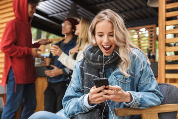 Poster - Cheerful young girl using mobile phone