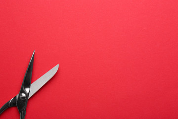 Pair of sharp scissors on color background, top view. Space for text