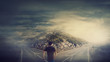 © 1STunningART - Rear view man walking in front of crossroad as road is split in two different ways. Choosing the correct path between left and right, failure or success. Difficult decision concept
