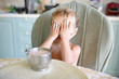 © Westend61 - Little girl at dining table covering her eyes