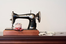 Old Vintage Sewing Machine With Measuring Tape And Pin Cushion In Shape Of A Hat