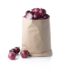 Wall Mural - Fresh purple onions in paper bag on white background