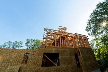 Residential construction home, wood beams with blue sky at construction