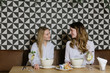 © Alvaro Hernandez/ADDICTIVE STOCK - Two pretty ladies smiling and having healthy lunch in cozy restaurant together