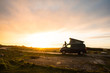 © Carles Alonso/ADDICTIVE STOCK - Man silhouette standing on caravan trailer on lonely country road at sunset in Wales
