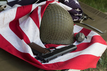 Soldier Helmet, Pistolt And Grenade From The Second World War And The Flag Of The USA. Patriotism