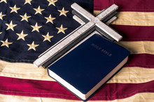 Wood Cross And Blue Bible On Old Looking Tea Stain American Flag