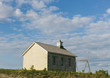 © Mint Images - Tallgrass Prairie Preserve, a historic school house building and a cottonwood tree and a set of rusty swings, in spring. ,Joseph H. Williams Tallgrass Prairie Preserve