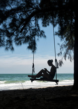 Thailand, Krabi, Lao Liang Island, Woman On Tree Swing On The Beach