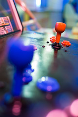 Detail on a red joystick of an old vintage arcade game