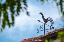 Rooster Weather Vane On Roof Of House 