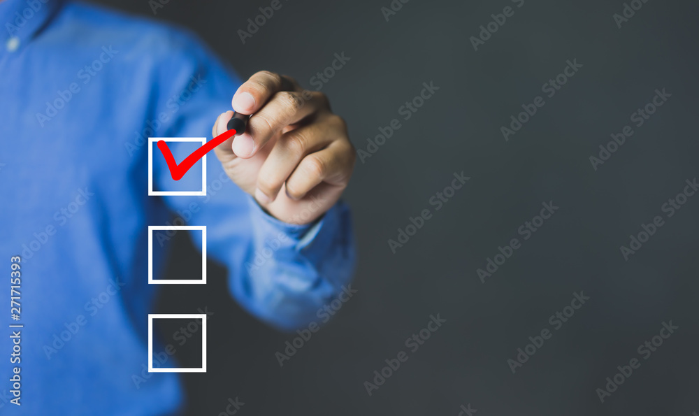 Checklist concept, Businessman checking mark on the check boxes with marker red, copy space - obrazy, fototapety, plakaty 