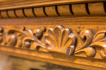 Wall Mural - Close-up detail of carved wooden decorative piece of furniture with floral ornament made of natural hardwood. Art craft and design concept.