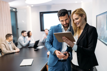 Poster - Businesspeople discussing while using digital tablet in office