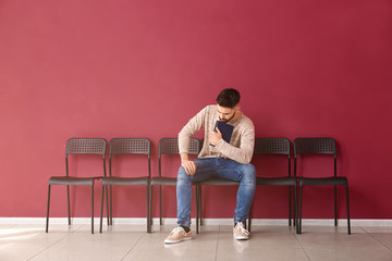 Young man waiting for job interview indoors