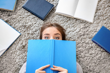 Wall Mural - Female student reading books at home