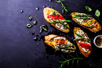 Wall Mural - Toasts (sandwiches) with cheese, pepper and asparagus on black